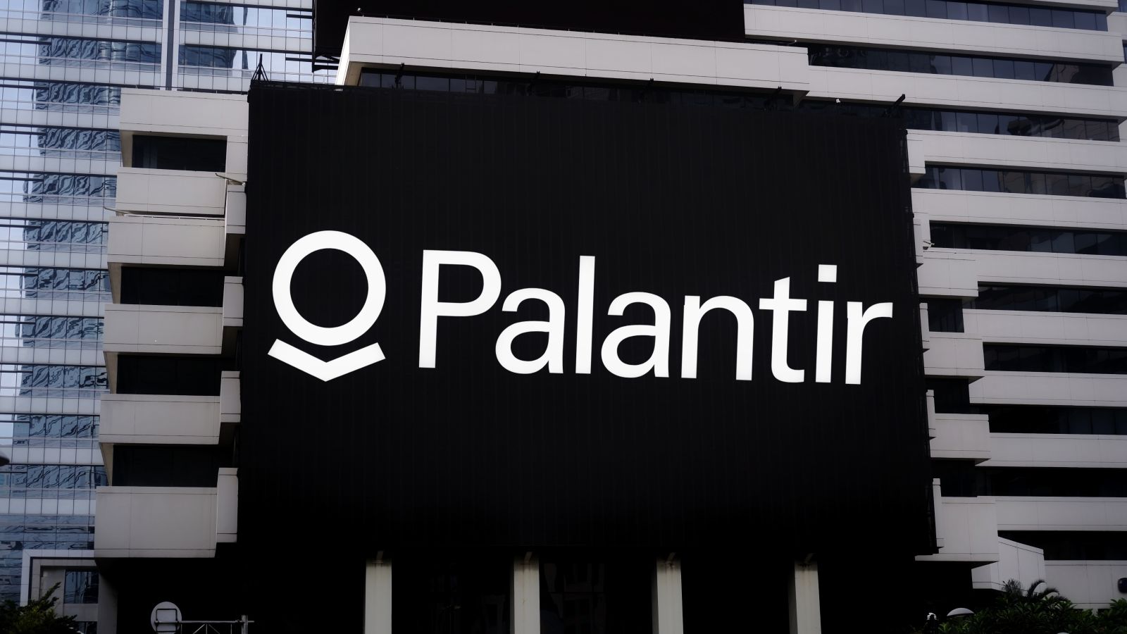 A Palantir sign displayed on an office building by Poetra_RH via Shutterstock